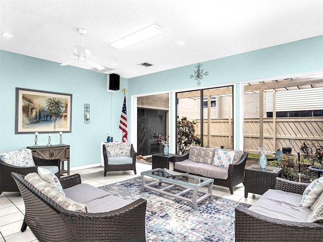 living room featuring light tile patterned floors and ceiling fan