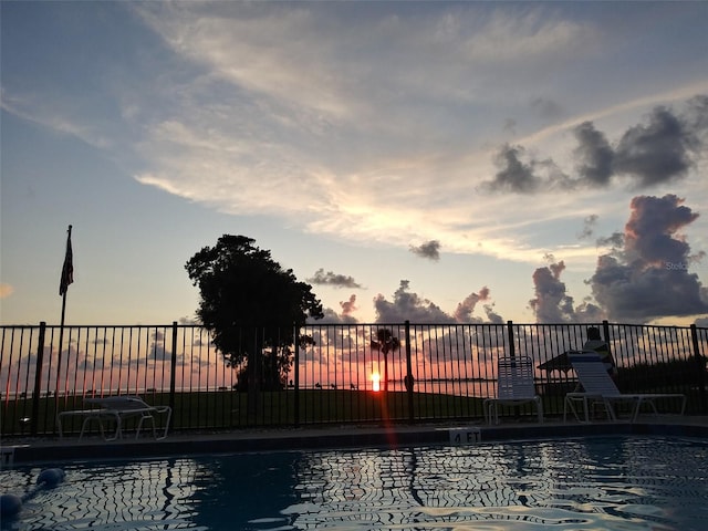 view of pool at dusk