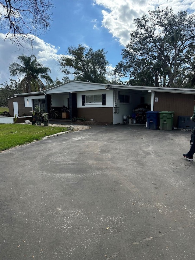 view of front of house featuring aphalt driveway and an attached carport