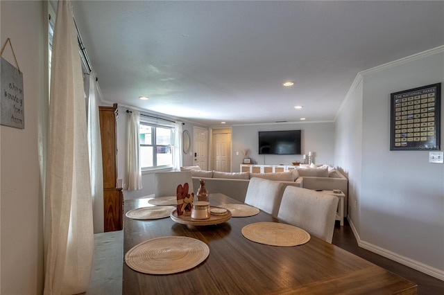 dining area featuring hardwood / wood-style floors and crown molding