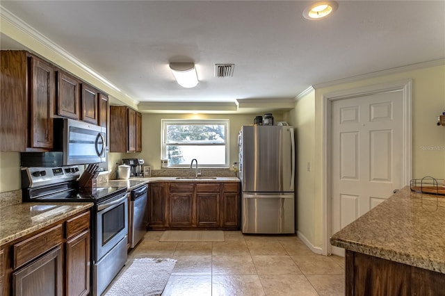 kitchen with sink, crown molding, dark brown cabinets, light tile patterned floors, and stainless steel appliances