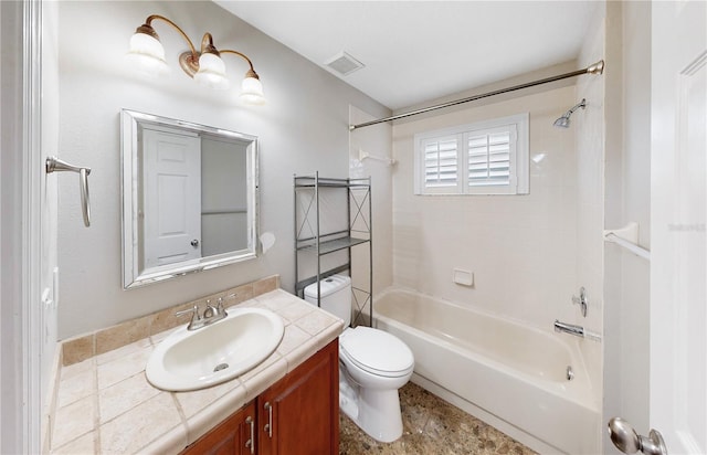 full bathroom featuring vanity, tiled shower / bath combo, and toilet