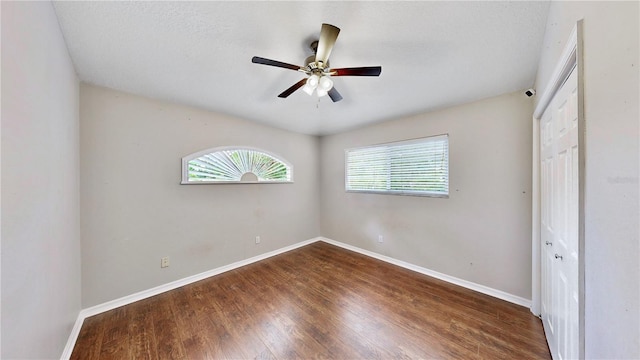 unfurnished bedroom with hardwood / wood-style flooring, ceiling fan, and a closet