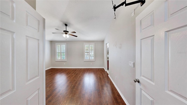 spare room featuring dark hardwood / wood-style flooring and ceiling fan