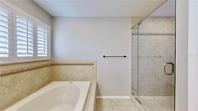 bathroom featuring tile patterned flooring and shower with separate bathtub