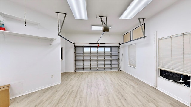 garage featuring cooling unit and a garage door opener