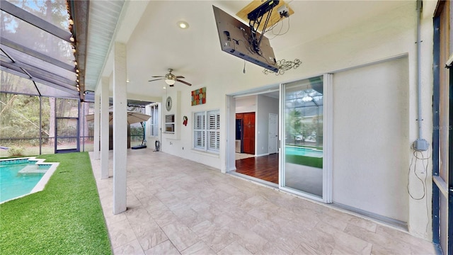 view of patio / terrace featuring a lanai and ceiling fan