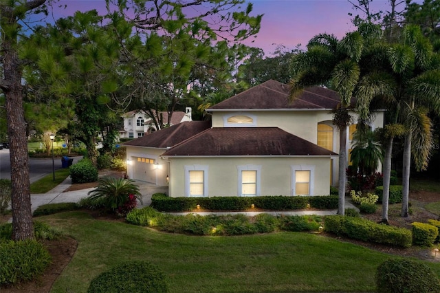 view of front facade featuring a garage and a yard