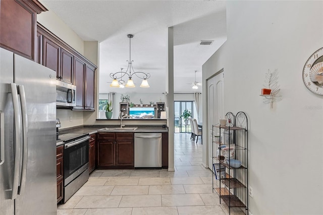 kitchen with sink, hanging light fixtures, light tile patterned floors, stainless steel appliances, and ceiling fan with notable chandelier