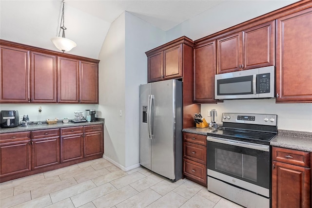 kitchen featuring hanging light fixtures, appliances with stainless steel finishes, and lofted ceiling