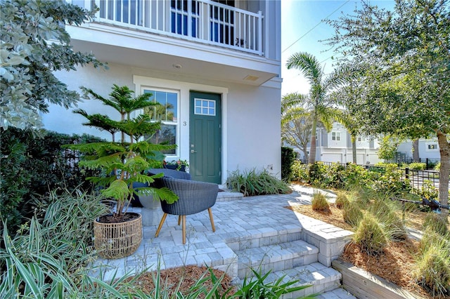 doorway to property featuring a patio area and a balcony