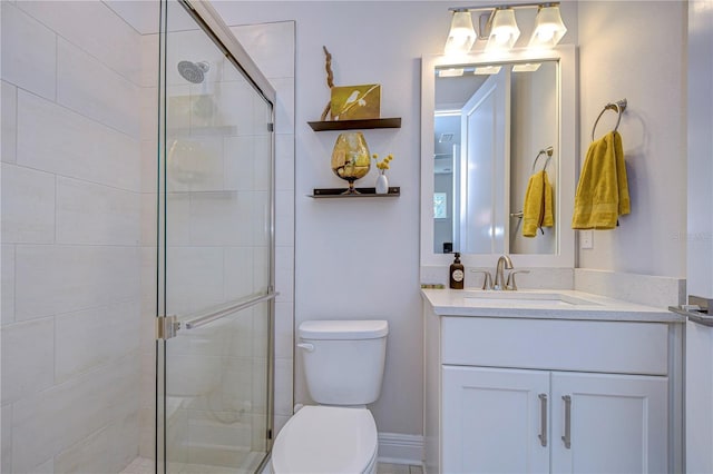 bathroom with walk in shower, vanity, and toilet