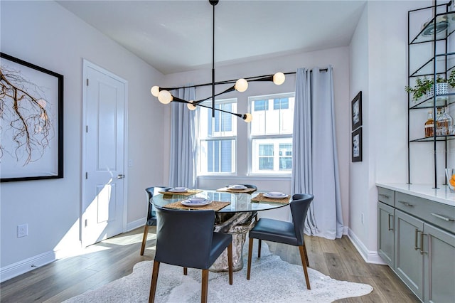 dining area with a chandelier and light hardwood / wood-style flooring