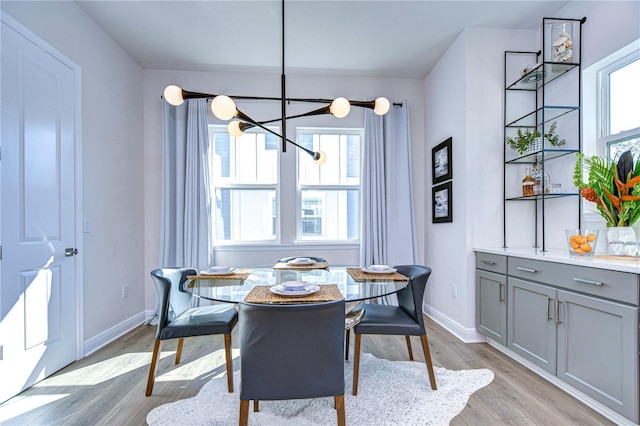 dining area with a chandelier and light hardwood / wood-style floors