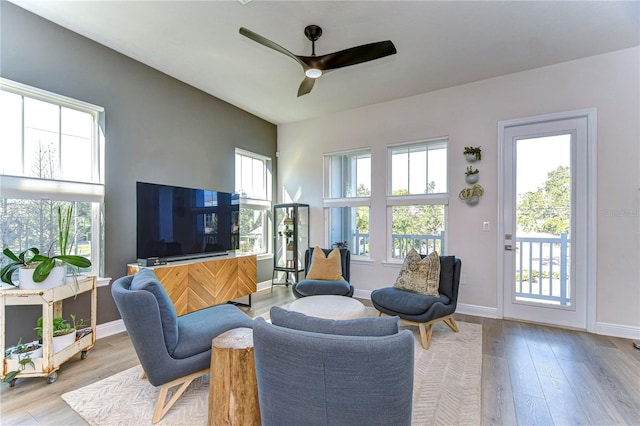 living room featuring ceiling fan and light wood-type flooring