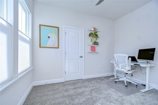 office space with light colored carpet and ceiling fan