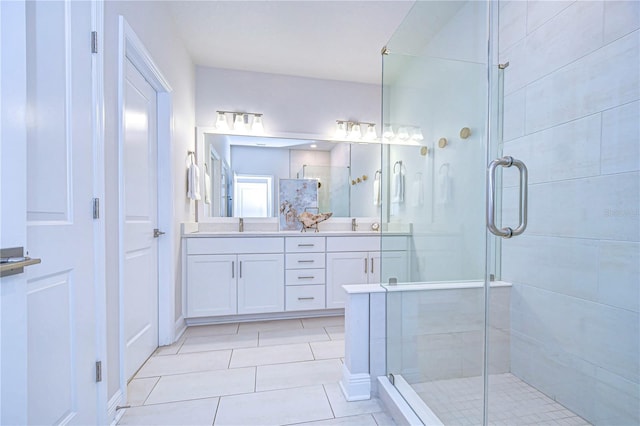 bathroom featuring tile patterned flooring, vanity, and a shower with shower door