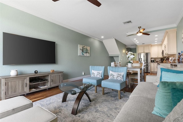 living room featuring crown molding, hardwood / wood-style flooring, and ceiling fan