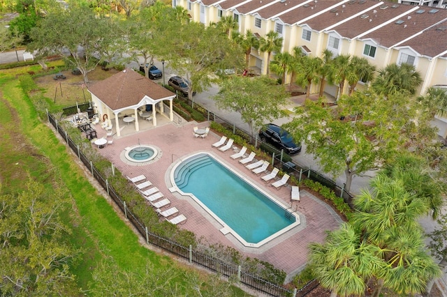 view of swimming pool with a community hot tub, an outdoor structure, and a patio