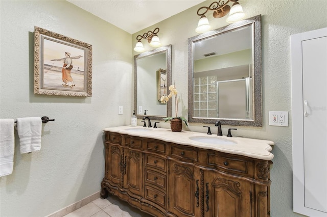 bathroom with tile patterned flooring, vanity, and a shower with door