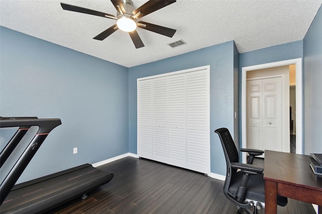 office area featuring ceiling fan, dark hardwood / wood-style flooring, and a textured ceiling