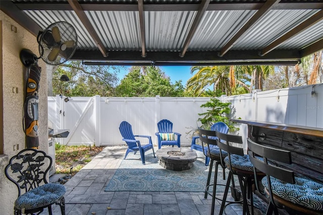 view of patio / terrace with an outdoor fire pit and exterior bar