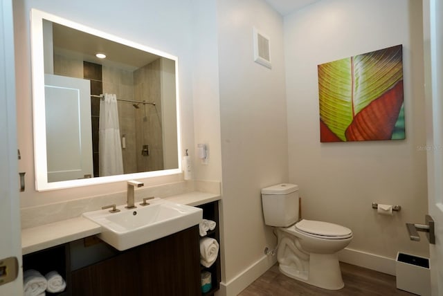15695 Grove Resort Ave Unit 4303, Winter Garden, FL 34787 - bathroom featuring baseboards, toilet, vanity, and wood finished floors