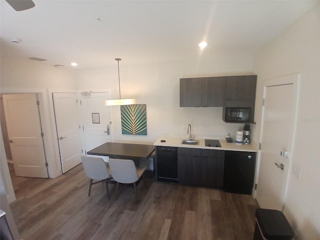 15695 Grove Resort Ave Unit 4303, Winter Garden, FL 34787 - kitchen featuring a sink, dark wood-type flooring, black microwave, light countertops, and hanging light fixtures