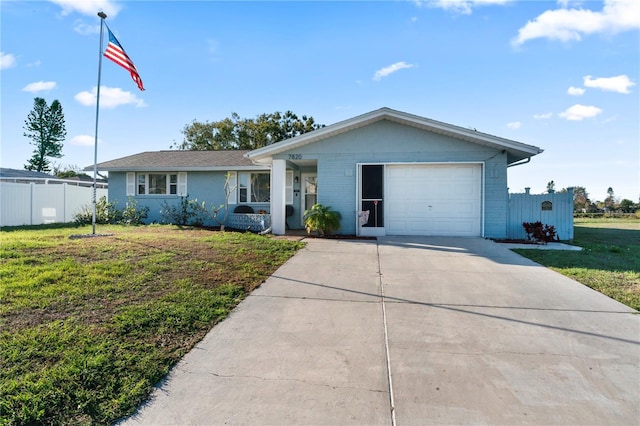 ranch-style home featuring a front lawn and a garage