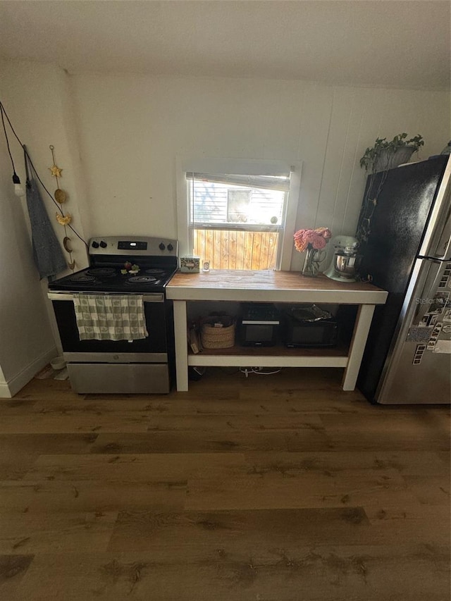 kitchen with stainless steel appliances and hardwood / wood-style floors