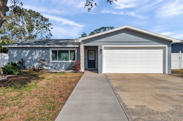 ranch-style house featuring a garage and a front lawn