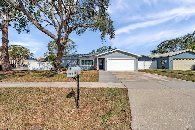 ranch-style house with a garage and a front lawn