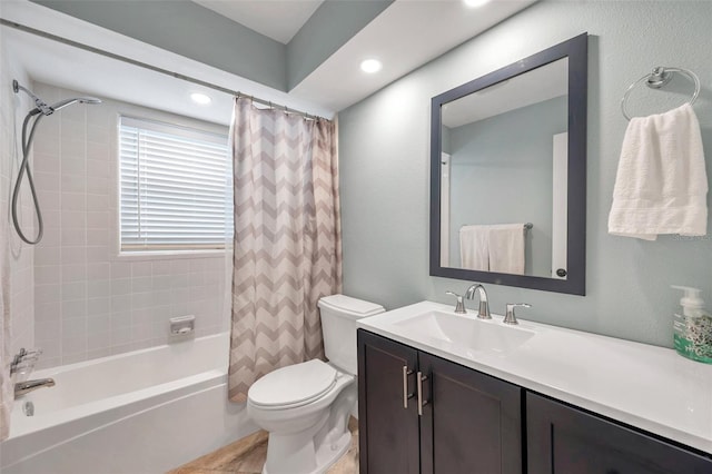 full bathroom with vanity, shower / bath combination with curtain, and toilet