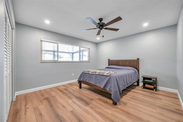 bedroom with ceiling fan and light hardwood / wood-style flooring