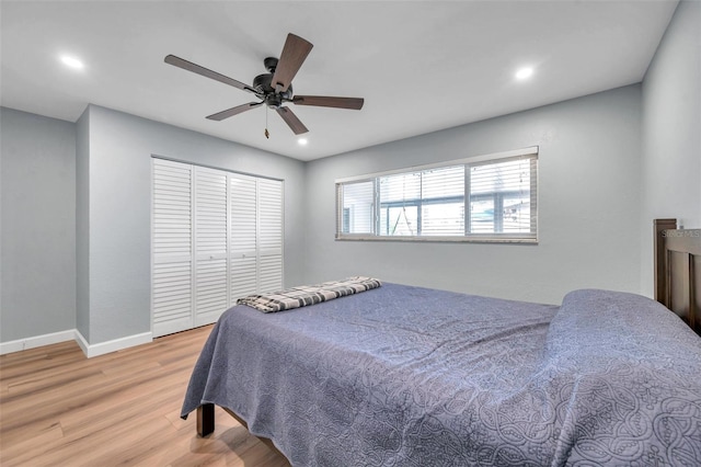 bedroom featuring a closet, ceiling fan, and light hardwood / wood-style flooring