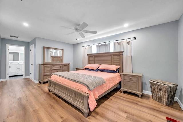 bedroom featuring light hardwood / wood-style flooring, ceiling fan, and ensuite bathroom