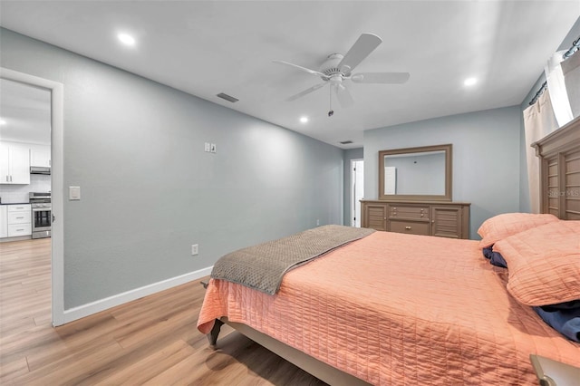 bedroom with ceiling fan and light hardwood / wood-style floors