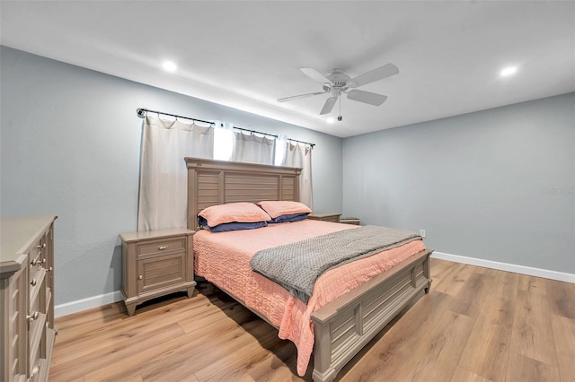 bedroom with light hardwood / wood-style flooring and ceiling fan