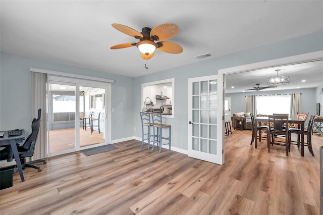 office featuring french doors, ceiling fan, and light hardwood / wood-style flooring