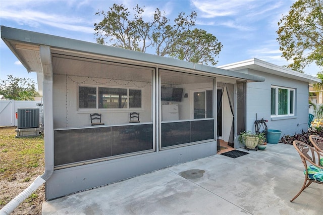 back of property featuring a sunroom, a patio, and central air condition unit