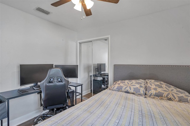 bedroom featuring wood-type flooring, a closet, and ceiling fan