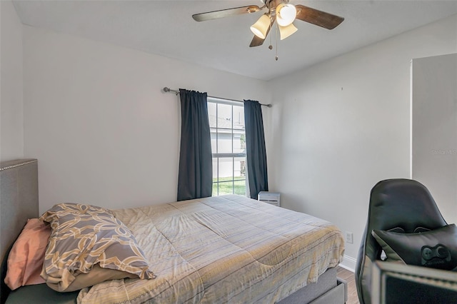 bedroom with hardwood / wood-style flooring and ceiling fan