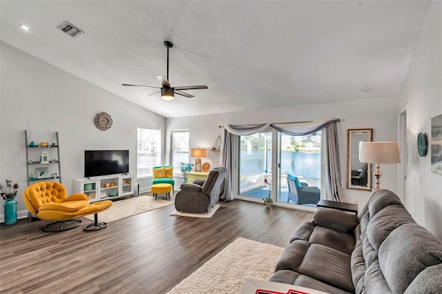 living room with ceiling fan, plenty of natural light, vaulted ceiling, and wood-type flooring