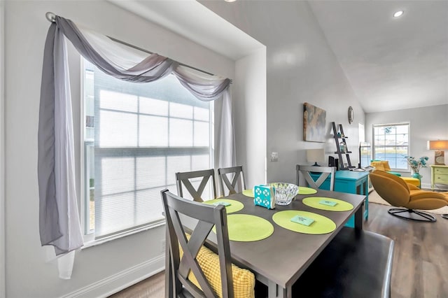 dining area with lofted ceiling and hardwood / wood-style floors