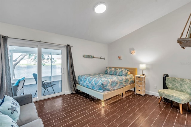 bedroom with lofted ceiling and access to exterior