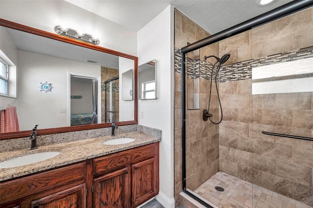 bathroom featuring vanity and a shower with shower door