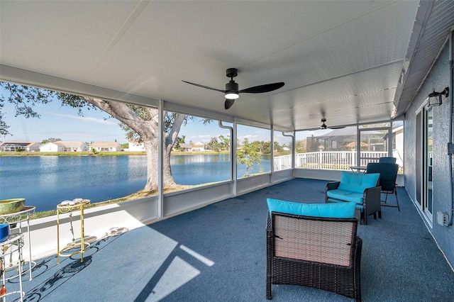 sunroom featuring a water view