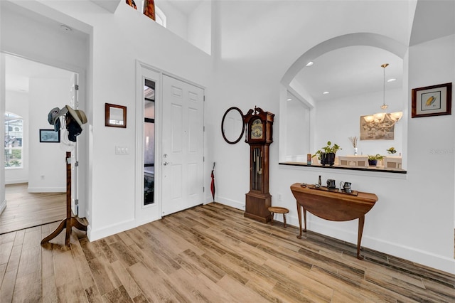 entrance foyer with a notable chandelier and hardwood / wood-style flooring