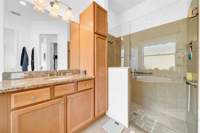 bathroom with vanity, tile patterned floors, and a shower with door