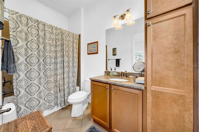 bathroom featuring tile patterned flooring, vanity, and toilet